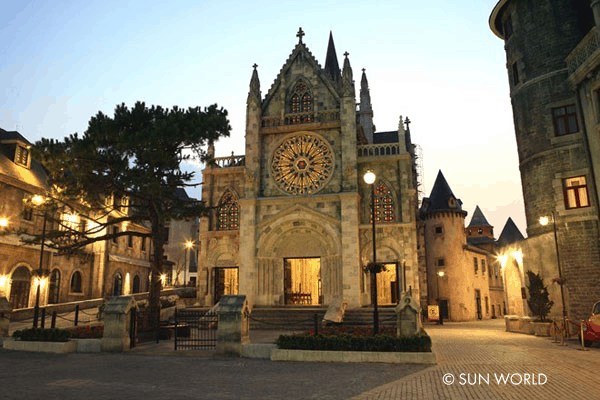 St Denis Tower lit up at night at Ba Na Hills French Village